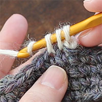 こま編み2目一度[6] もう一度糸をかけて、一気に3つのループをくぐらせます。